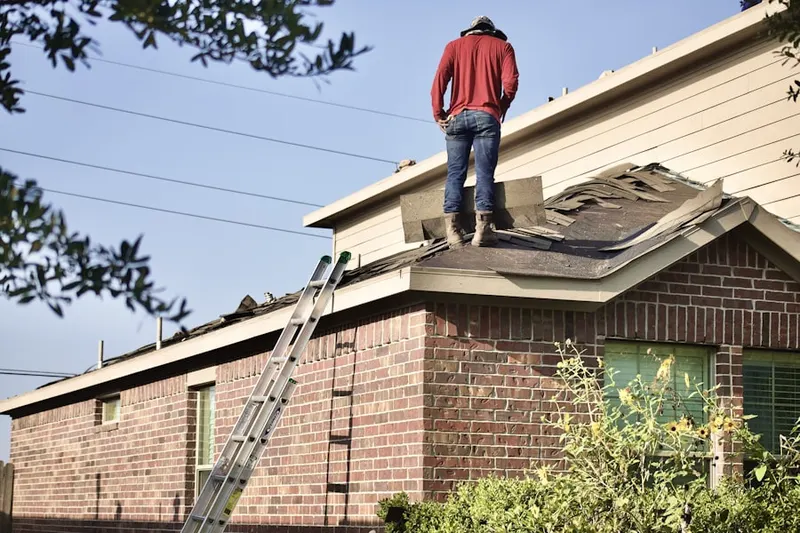 Professional roofer working on a residential roof in Westbrook
